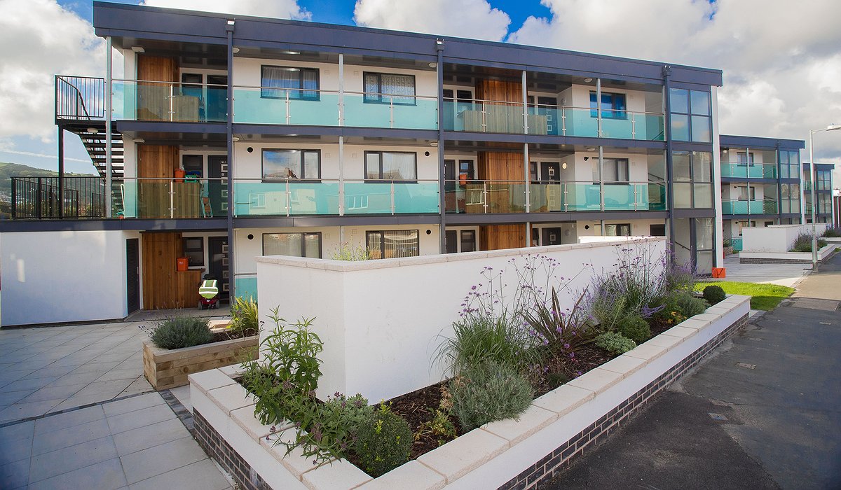 New and improved glass balconies, wooden exterior and grey double glazing to flats in Caradoc Road, Prestatyn