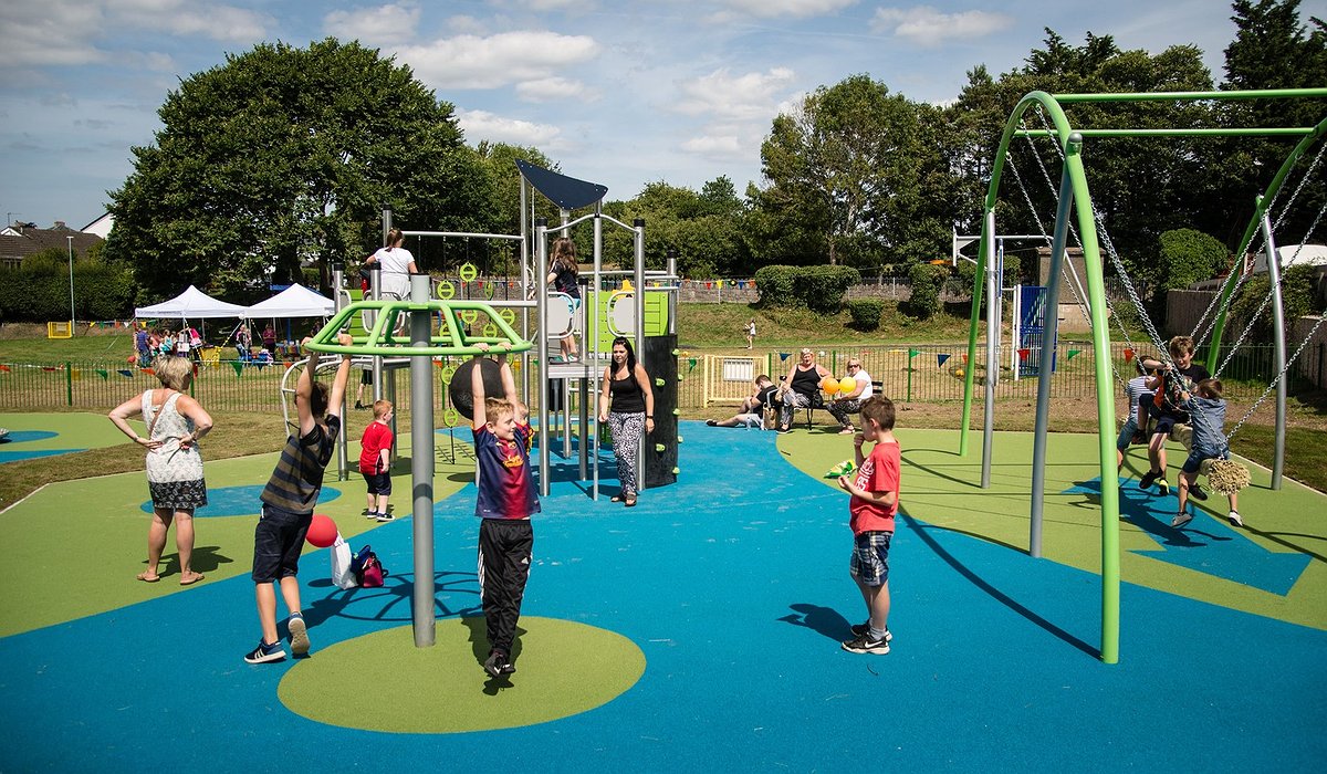 Children playing on new colourful play area equipment in Henllan