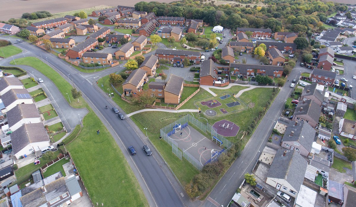 Aerial photo of houses, play area and woodland at Bruton Park estate in Rhyl