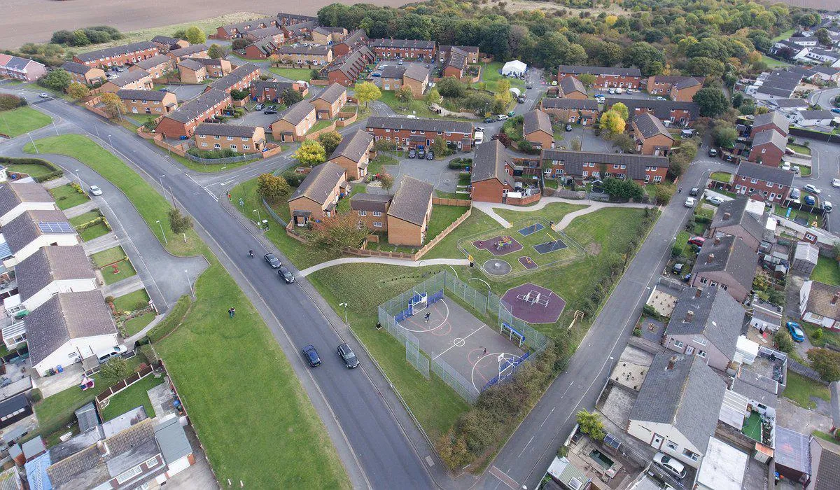 Aerial photo of houses, play area and woodland at Bruton Park estate in Rhyl