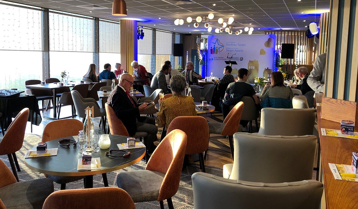 People seated around tables at the Denbighshire Housing and Tenants Awards event in 2022.