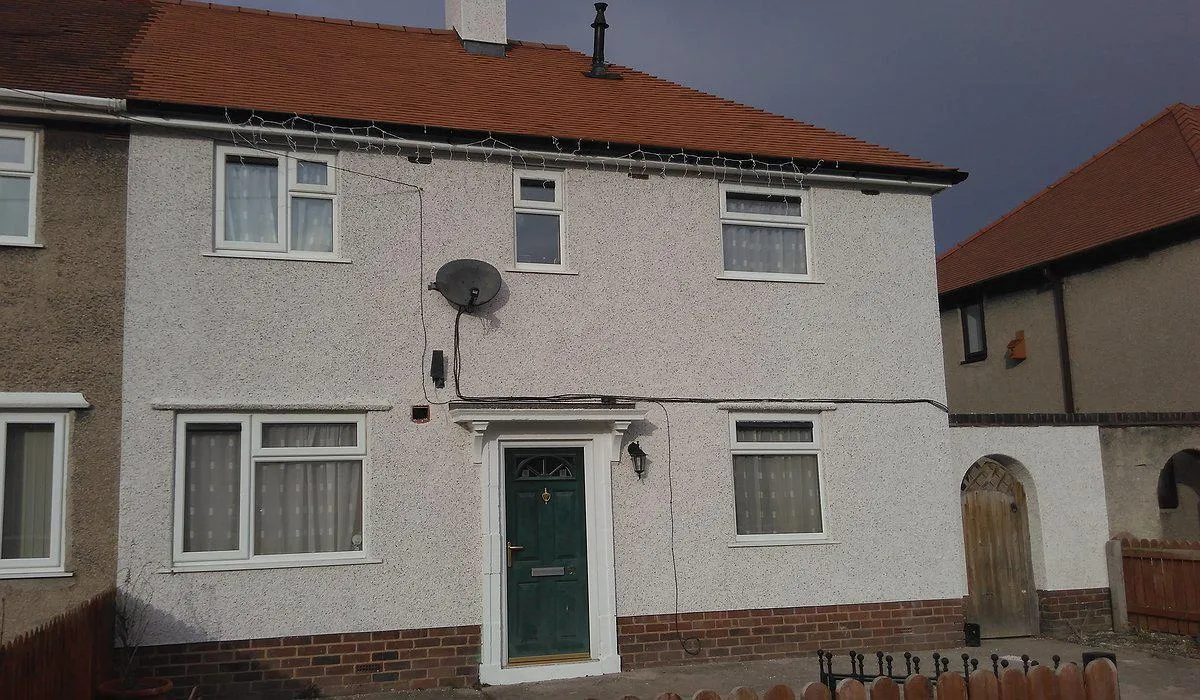 External enveloping scheme with new render and roof