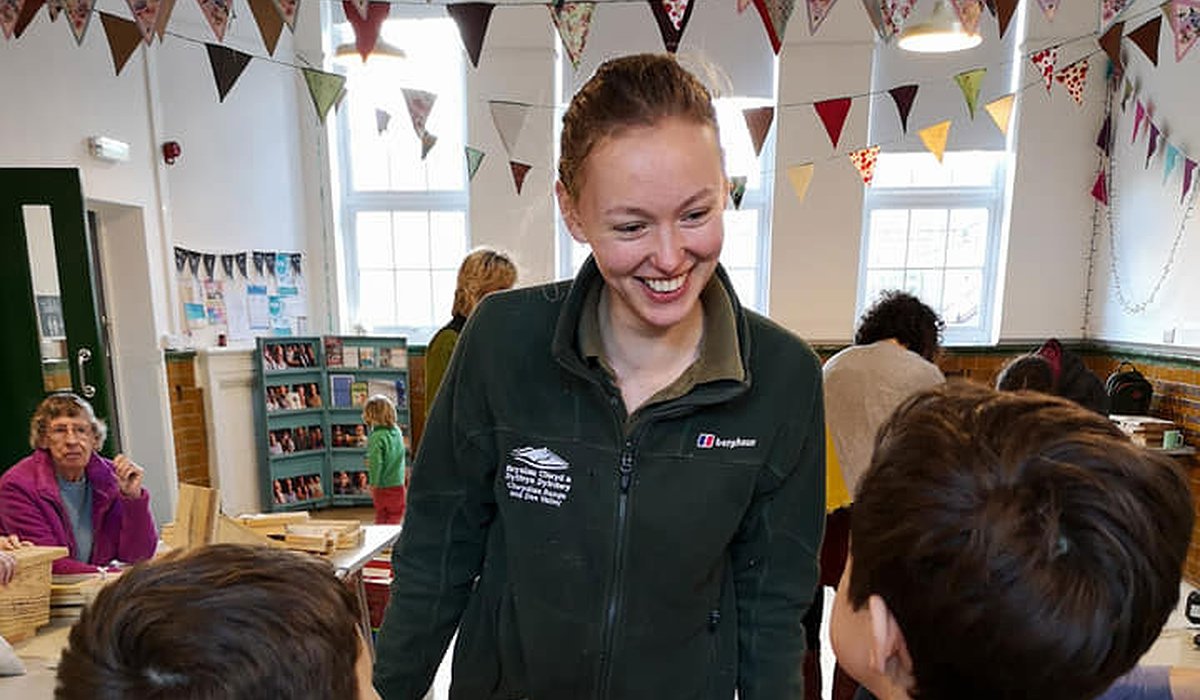 Two young children and a female adult bird box building as part of the Nature for Health project