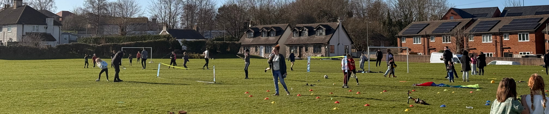 Sports field with lots of people around playing sports