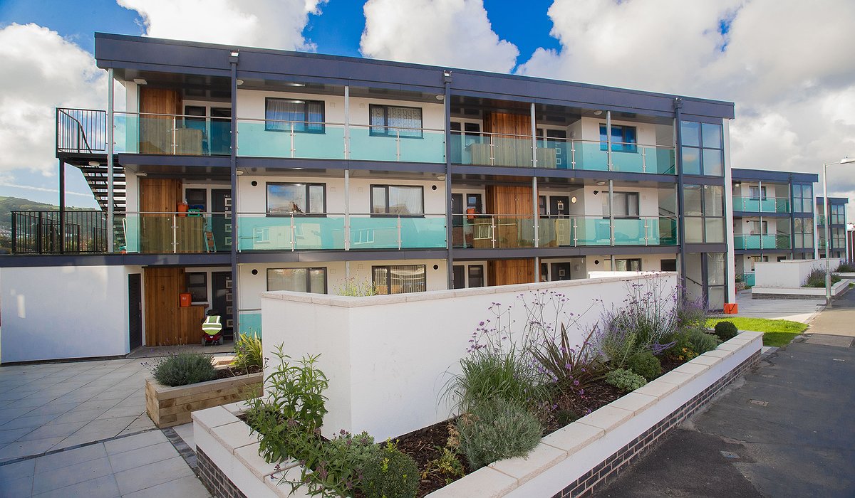 New and improved glass balconies, wooden exterior and grey double glazing to flats in Caradoc Road, Prestatyn.