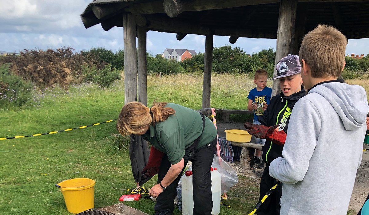 A group of children camp cooking at Glan Morfa as part of the Nature for Health project