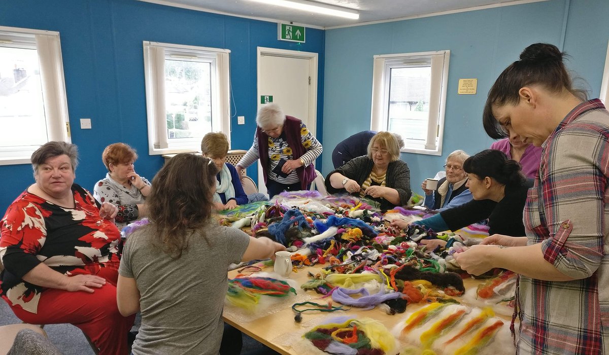 A group of women and young children felt making at Pengwern community centre as part of the Nature for Health project.