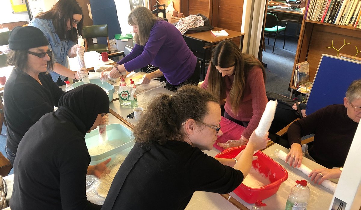 A group of people taking part in a felt making workshop in Prestatyn as part of the Nature for Health project.