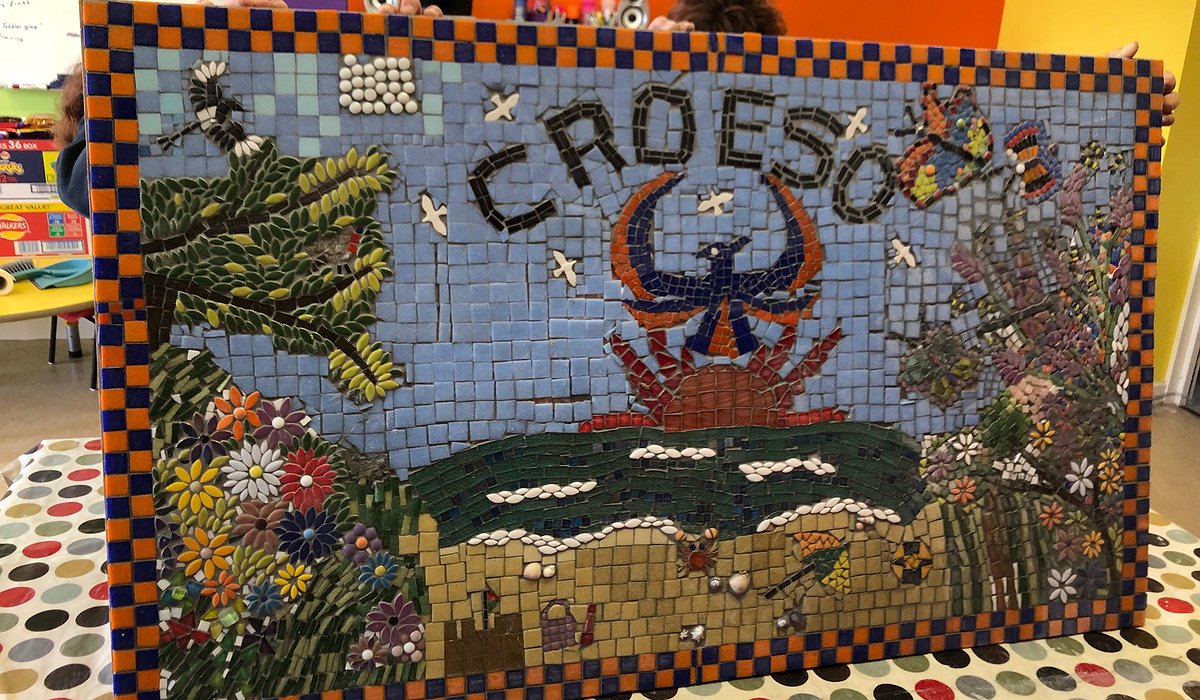 Volunteers at the Phoenix Centre in Rhyl completed a colourful nature themed tiled mosaic with a phoenix at the centre.