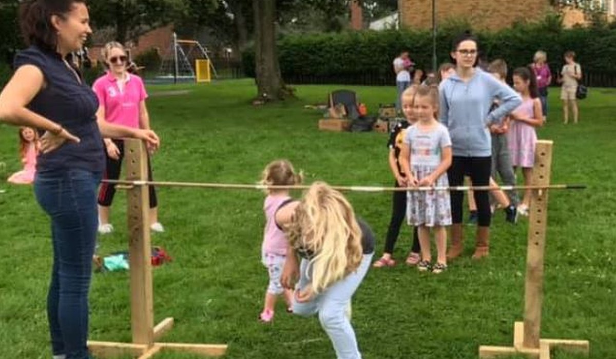 Children playing limbo stick as part of the Nature for Health project.